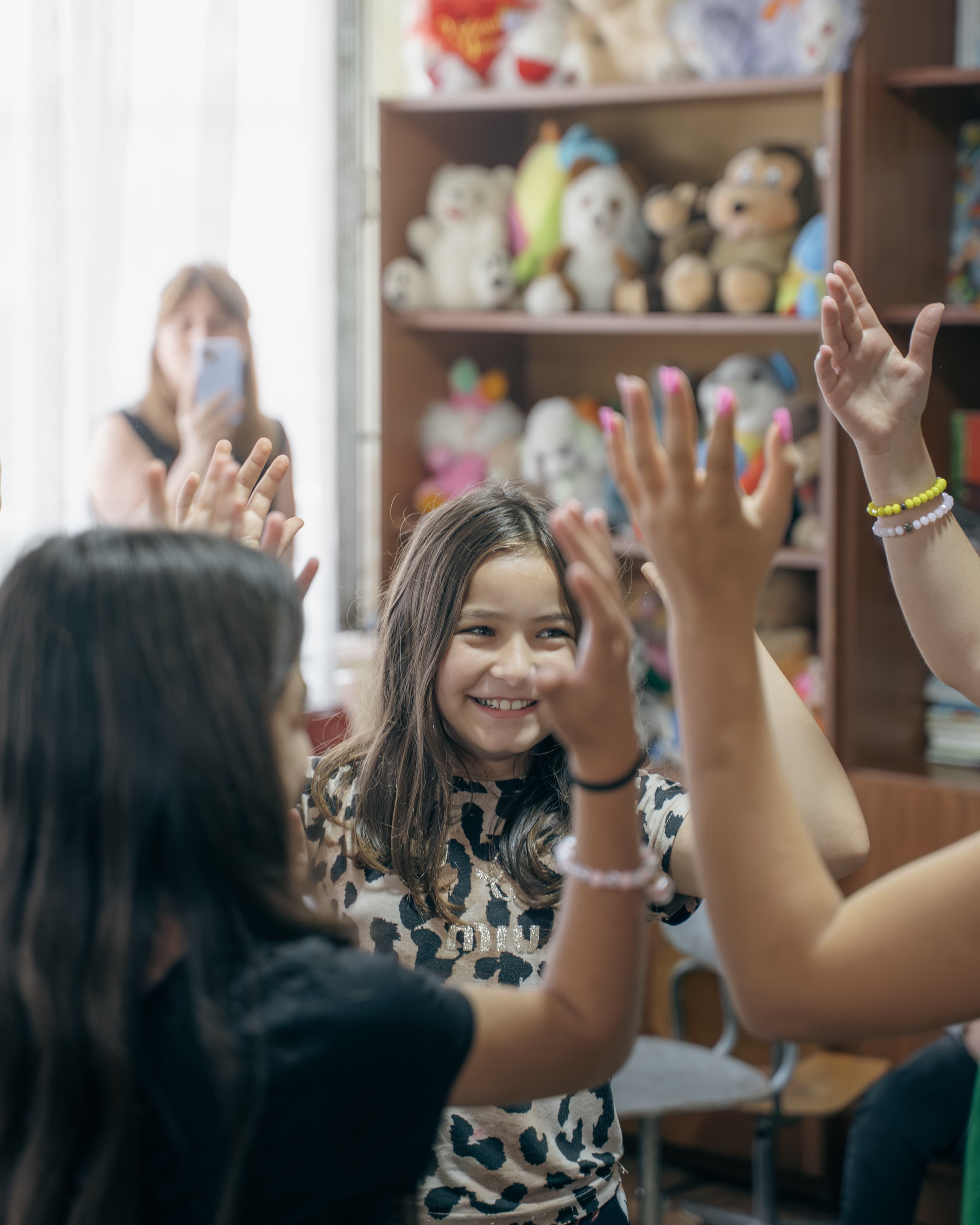 Girls high-fiving at Society Biliki