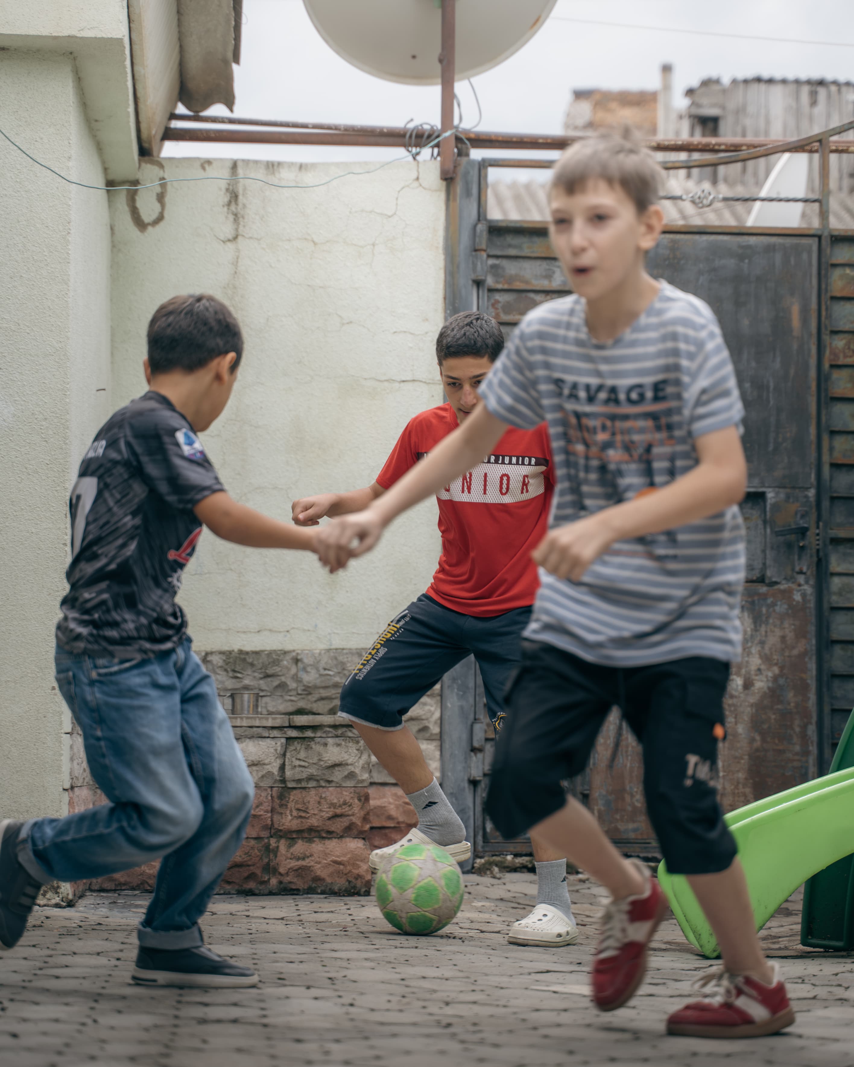 Kids playing soccer in a courtyard in Gori, Georgia