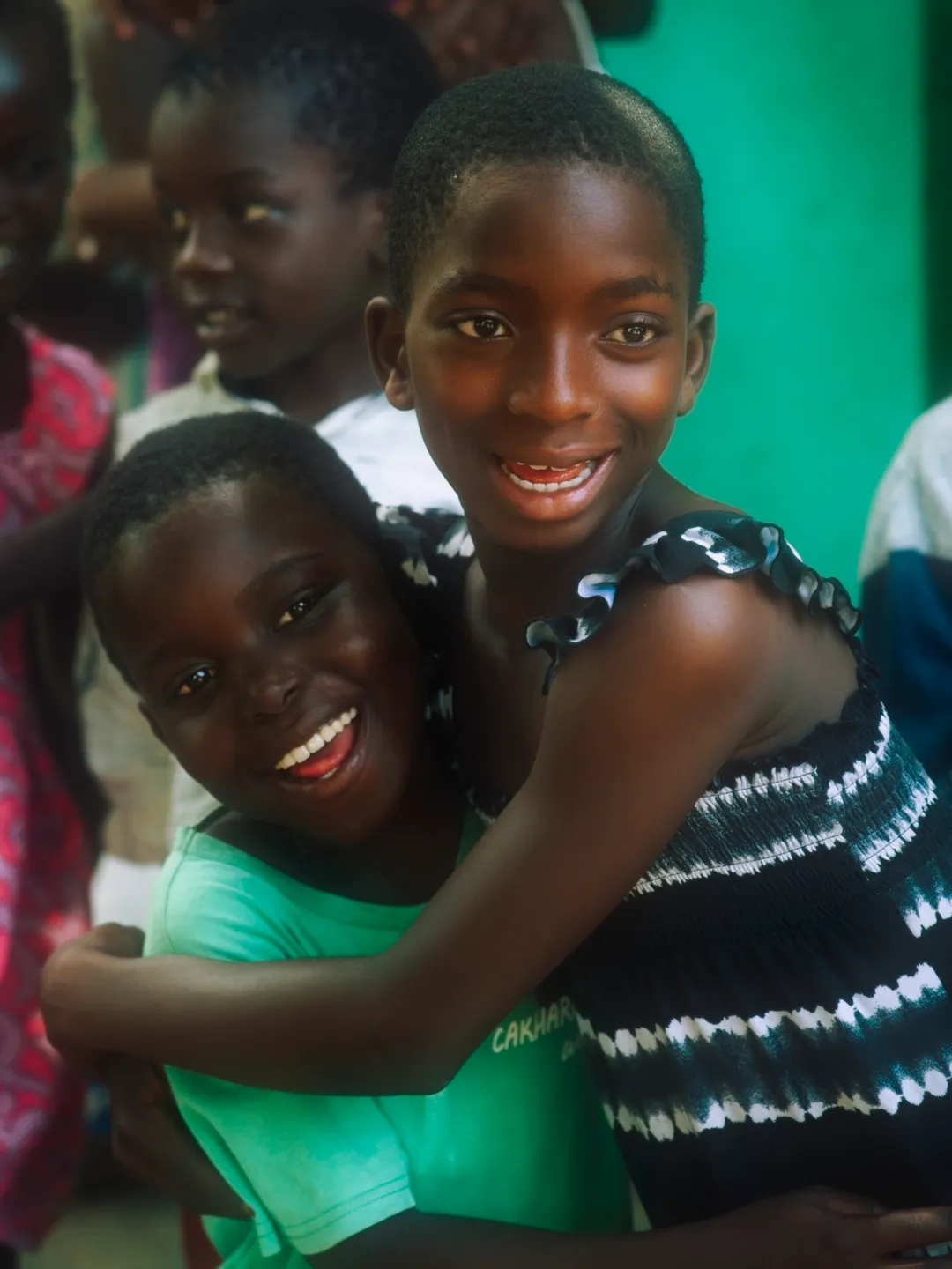 Two smiling girls hugging
