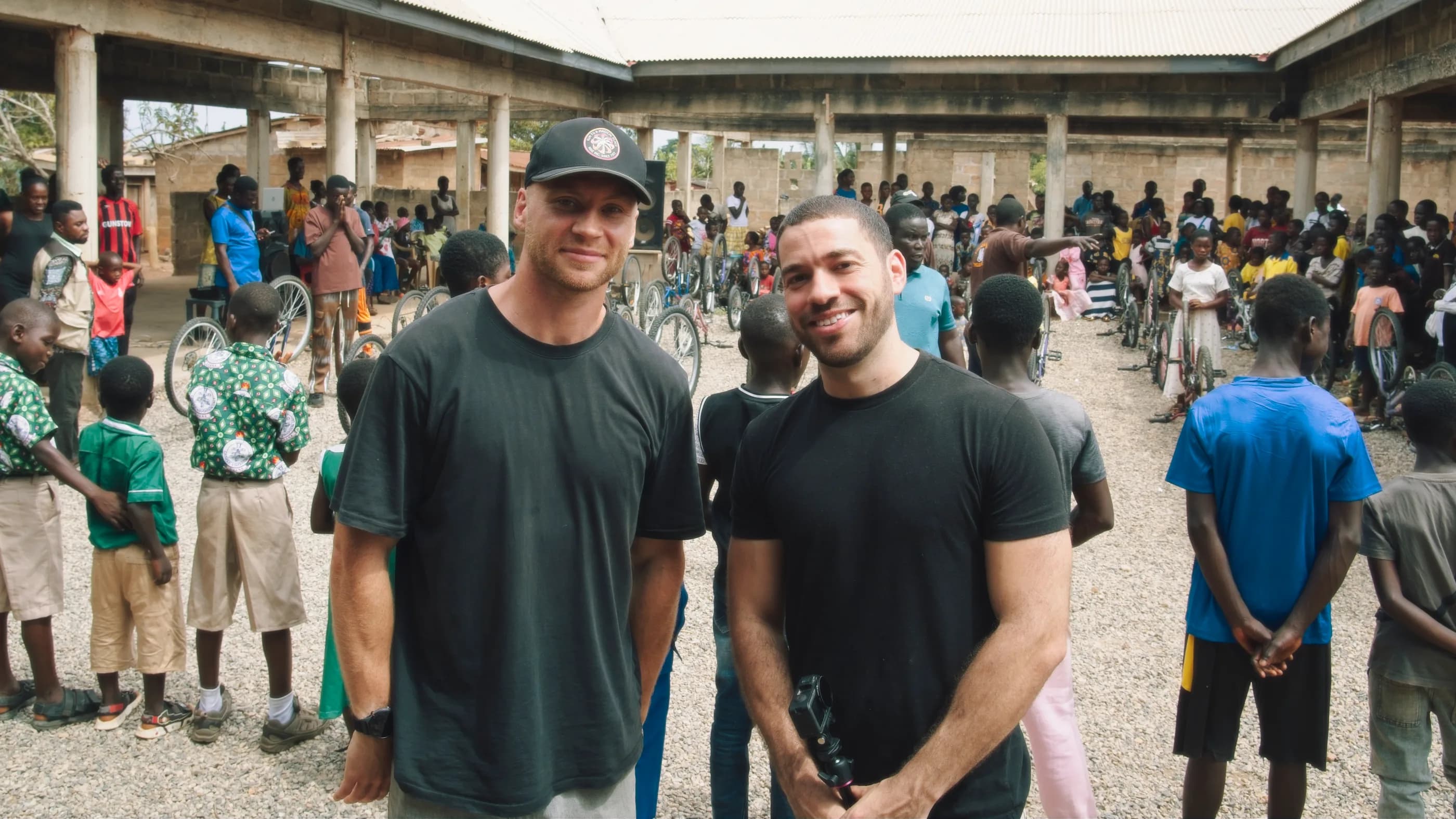 Patrik and Nathaniel with the kids and bikes on handover day in Ghana